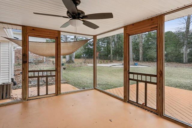 unfurnished sunroom featuring ceiling fan