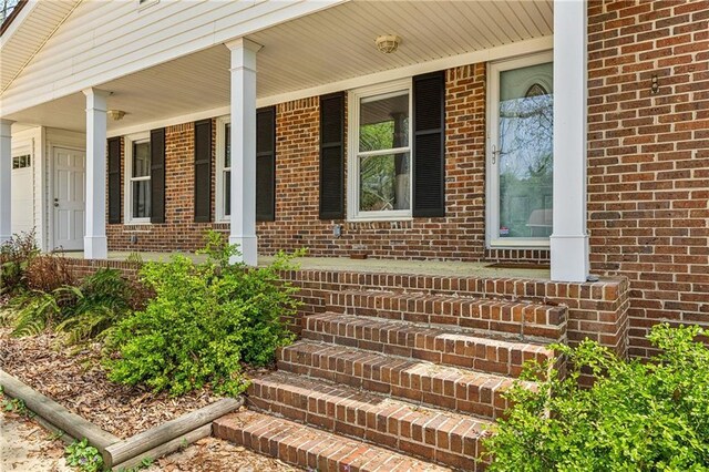 sitting room with hardwood / wood-style flooring, ornamental molding, and plenty of natural light