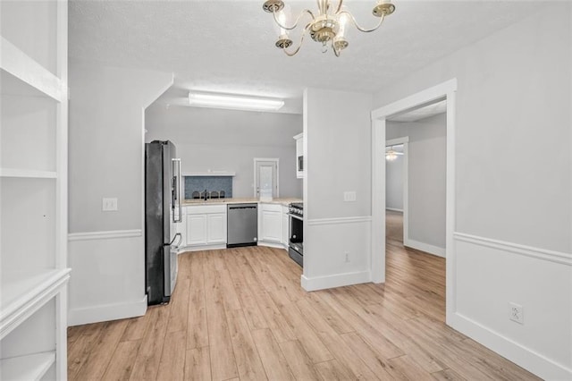 interior space featuring light hardwood / wood-style floors, sink, and a chandelier