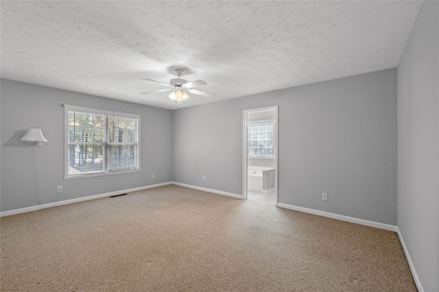 unfurnished room featuring ceiling fan and a textured ceiling