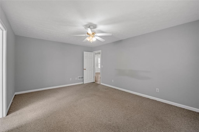 empty room featuring ceiling fan and carpet floors