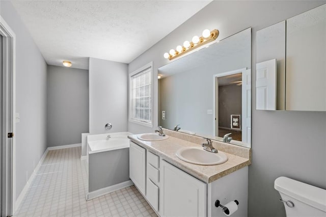 bathroom with toilet, a textured ceiling, and vanity