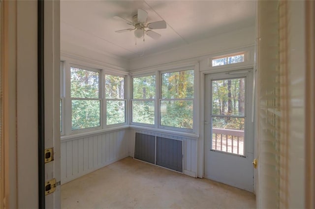 unfurnished sunroom with ceiling fan