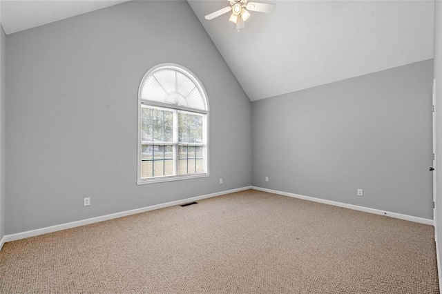 empty room with light colored carpet, high vaulted ceiling, and ceiling fan