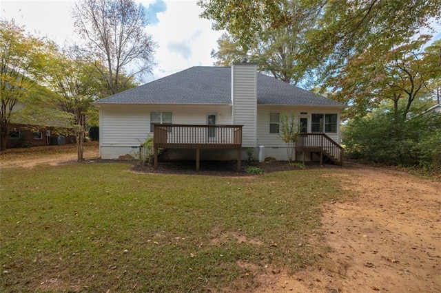 rear view of house featuring a lawn