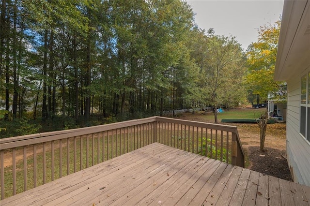 wooden deck featuring a lawn