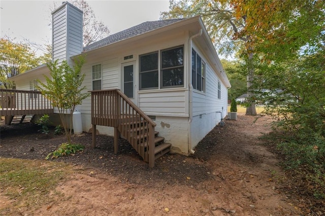 rear view of property featuring a deck and central AC unit