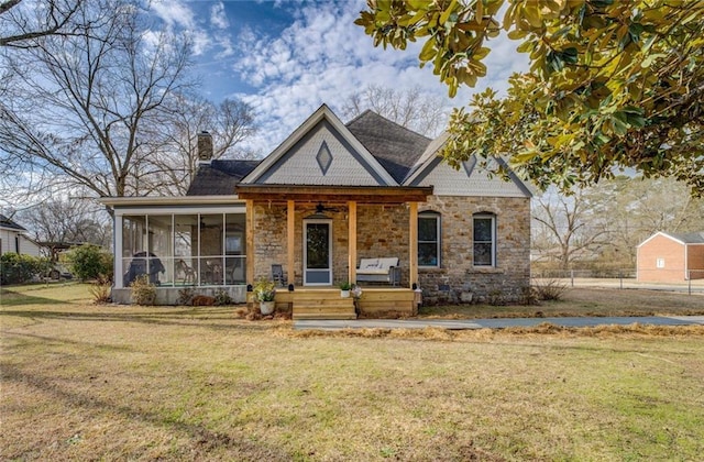 view of front of house featuring a front yard and a sunroom