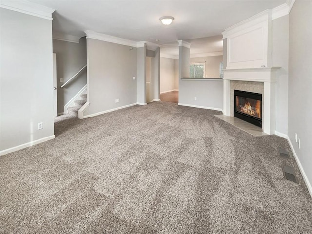 unfurnished living room with ornamental molding and carpet