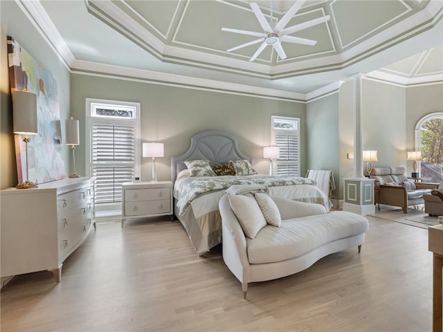 bedroom featuring crown molding, multiple windows, and light wood-type flooring