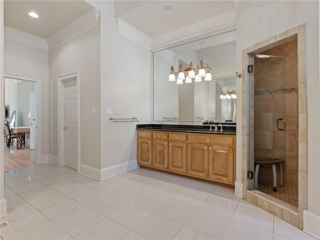 bathroom with baseboards, ornamental molding, a stall shower, tile patterned floors, and vanity