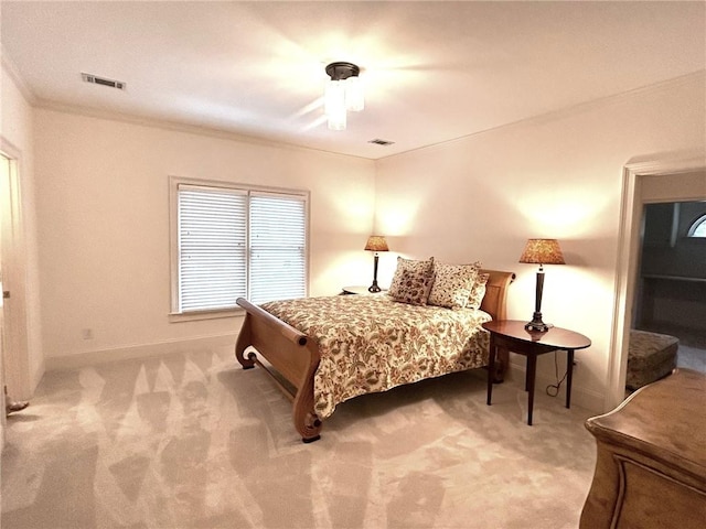 carpeted bedroom featuring ceiling fan, baseboards, visible vents, and ornamental molding