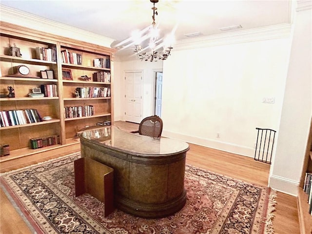 office featuring a chandelier, wood finished floors, and ornamental molding