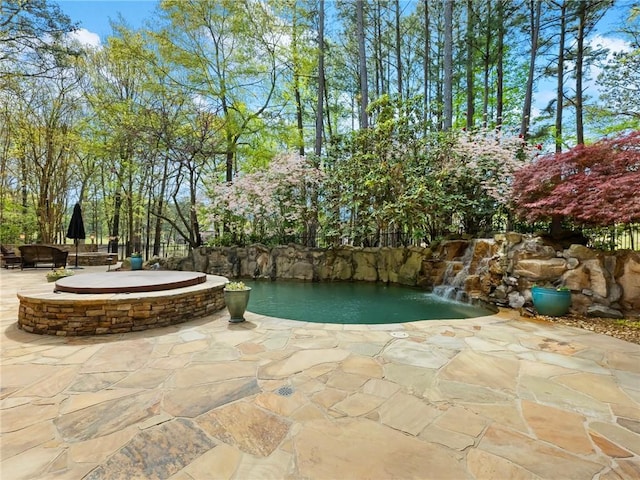 exterior space with an outdoor fire pit and a patio area