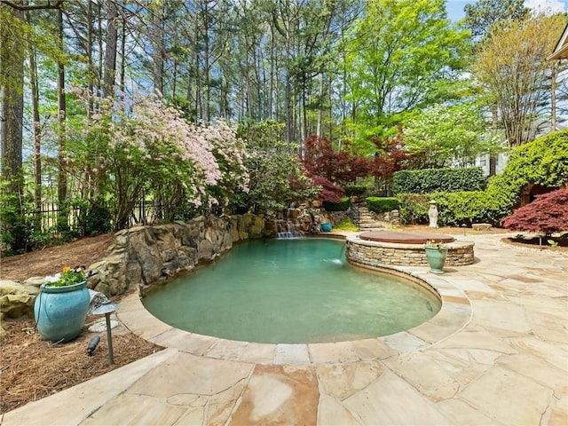 view of swimming pool featuring fence