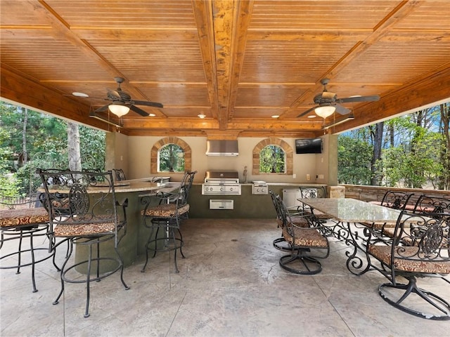 view of patio with area for grilling, outdoor dining area, a ceiling fan, and a grill