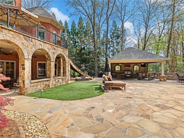 view of patio / terrace featuring a gazebo and a balcony