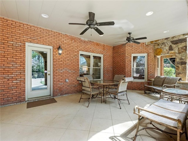 view of patio with outdoor dining area and a ceiling fan