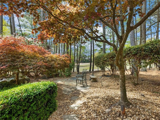 view of home's community featuring fence