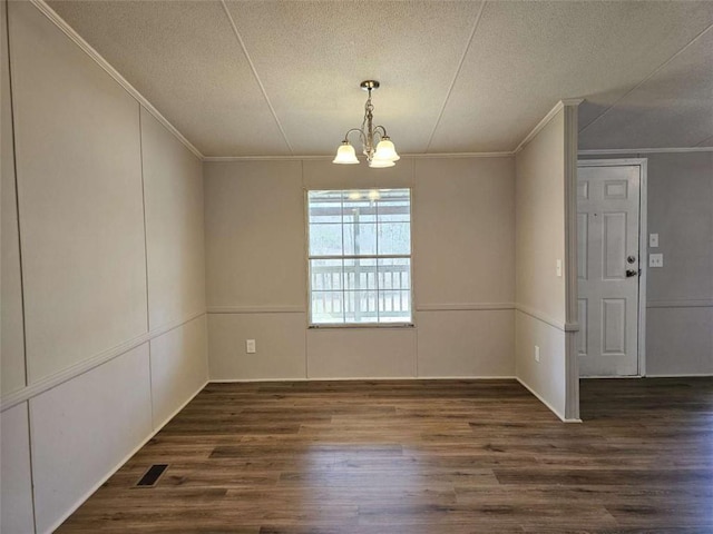 unfurnished dining area featuring a chandelier, visible vents, a textured ceiling, and dark wood-style floors