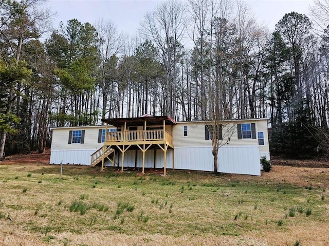 view of front of property featuring a front yard, stairway, and a wooden deck