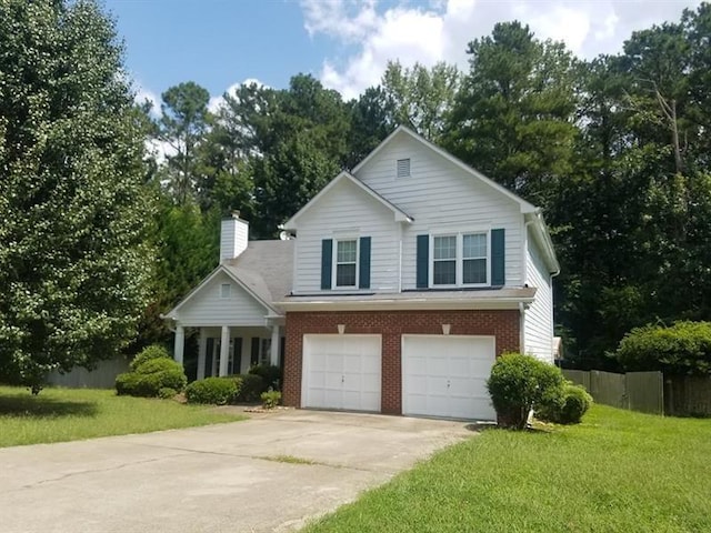 view of front facade featuring a chimney, a front yard, fence, concrete driveway, and an attached garage