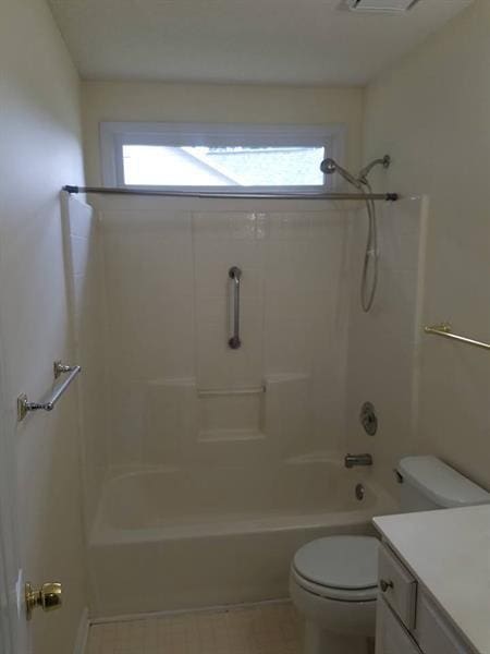 full bathroom with vanity, shower / bathing tub combination, toilet, and a wealth of natural light