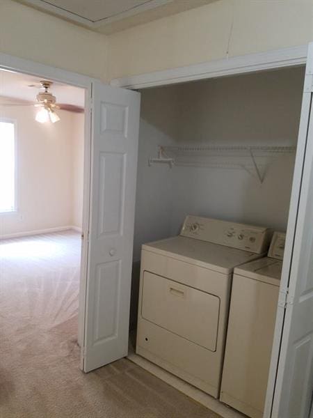 laundry room with washer and dryer, a ceiling fan, laundry area, and light colored carpet