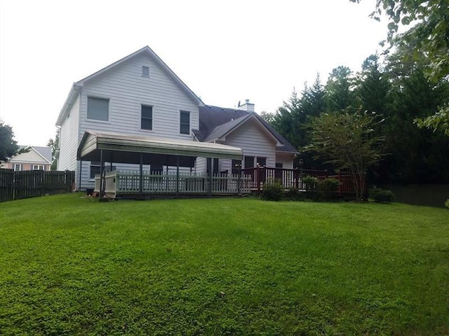 back of house with a lawn, fence, and a chimney