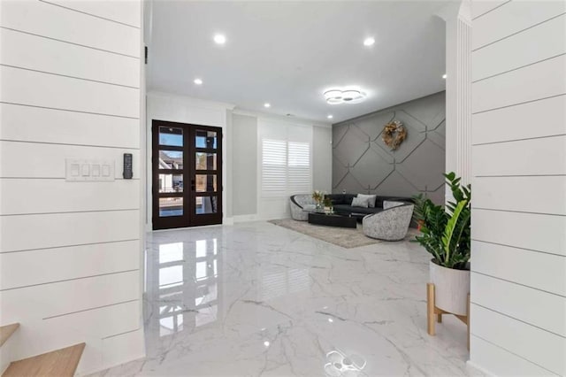 foyer entrance with recessed lighting, marble finish floor, and french doors