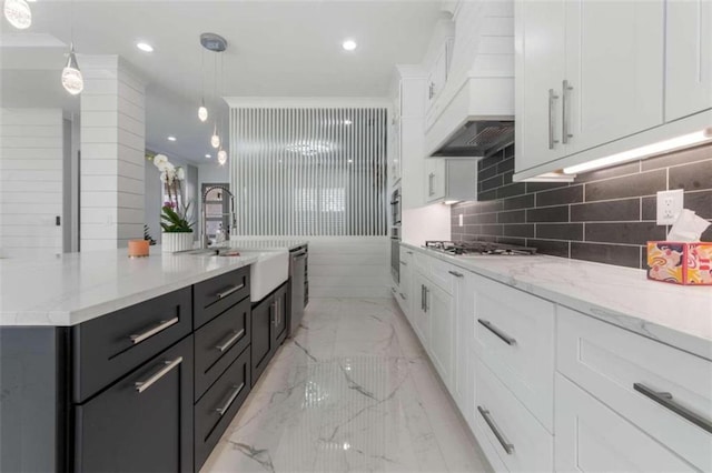 kitchen featuring appliances with stainless steel finishes, custom exhaust hood, marble finish floor, white cabinetry, and a sink