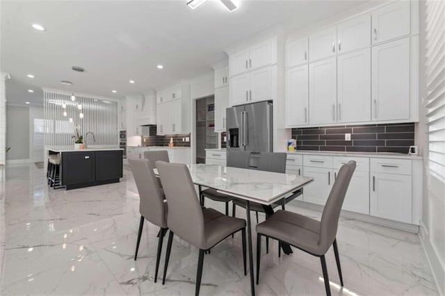 dining room featuring recessed lighting, marble finish floor, and baseboards