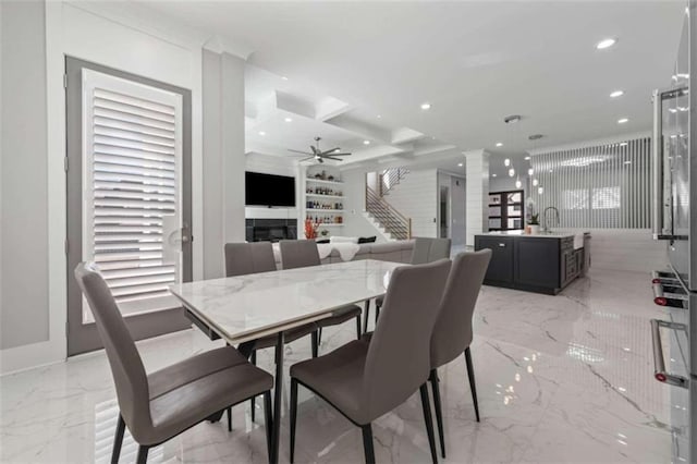 dining area with marble finish floor, a ceiling fan, recessed lighting, stairway, and a fireplace