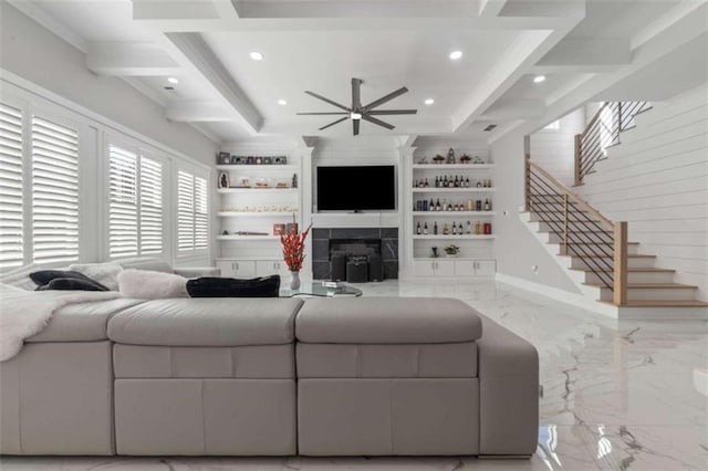 living area with beamed ceiling, marble finish floor, a fireplace, and stairway