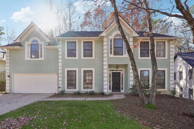 view of front of house with a front yard and a garage