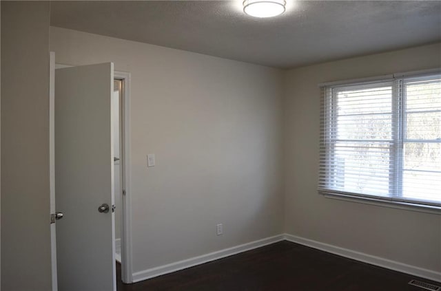 4940 Pinefield Dr, Macon, GA 31206 - spare room featuring healthy amount of natural light, dark wood-style flooring, and baseboards