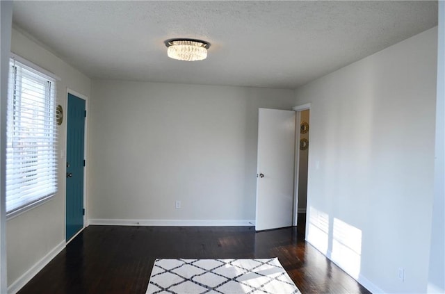 4940 Pinefield Dr, Macon, GA 31206 - empty room with dark wood-style floors, baseboards, and a textured ceiling