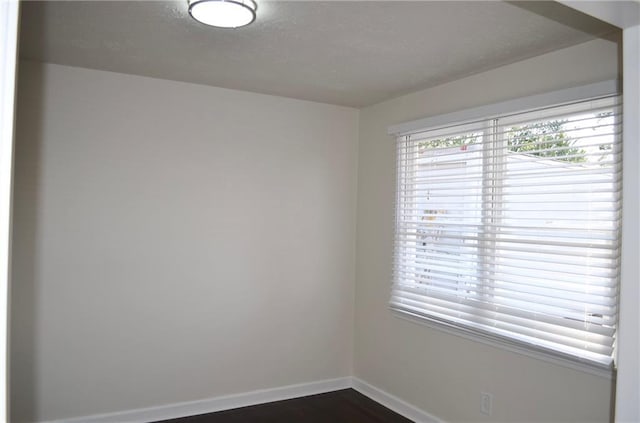 4940 Pinefield Dr, Macon, GA 31206 - spare room featuring baseboards, dark wood-style floors, and a textured ceiling