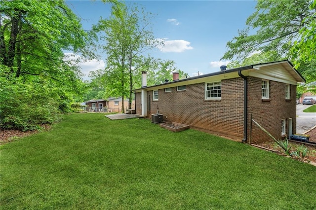 2015 Twelve Oaks Cir NW, Kennesaw, GA 30144 - rear view of property with a yard, a chimney, and brick siding