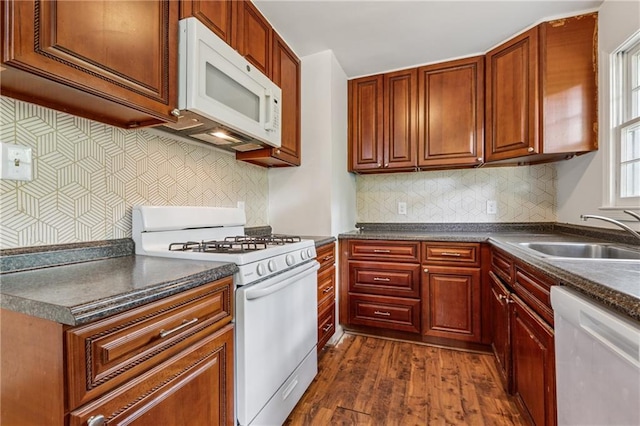 2015 Twelve Oaks Cir NW, Kennesaw, GA 30144 - kitchen with a sink, white appliances, backsplash, dark wood-style floors, and dark countertops