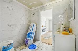 bathroom with a shower and tile walls