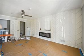 unfurnished living room with ceiling fan