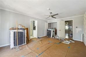 unfurnished living room with ceiling fan and ornamental molding