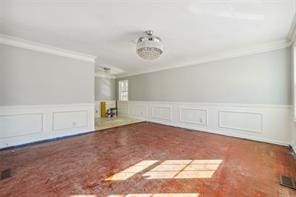 interior space with ornamental molding and carpet