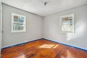 spare room featuring hardwood / wood-style floors