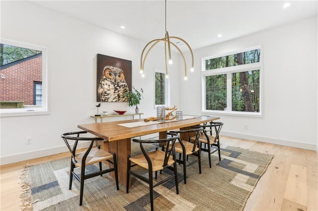 dining space with plenty of natural light and light wood-type flooring