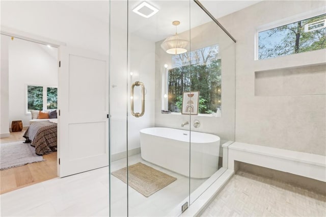 bathroom featuring a bath and a wealth of natural light