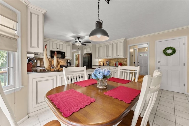 1083 Wash Lee Dr SW, Lilburn, GA 30047 - dining room featuring light tile patterned floors, ceiling fan, and crown molding
