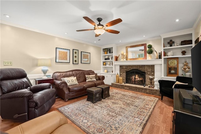 1083 Wash Lee Dr SW, Lilburn, GA 30047 - living room with a ceiling fan, wood finished floors, built in features, a brick fireplace, and ornamental molding
