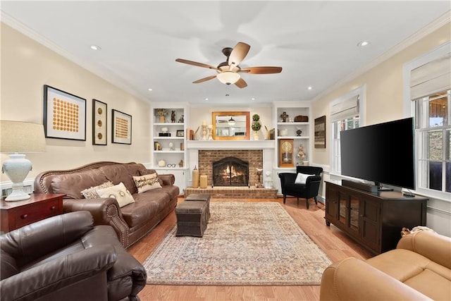 1083 Wash Lee Dr SW, Lilburn, GA 30047 - living room with a ceiling fan, light wood-style flooring, built in features, a fireplace, and crown molding